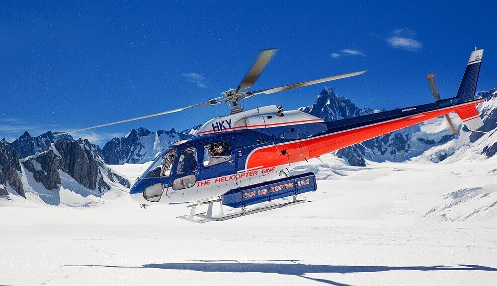Helicopter landing on snowy mountain in August in New Zealand