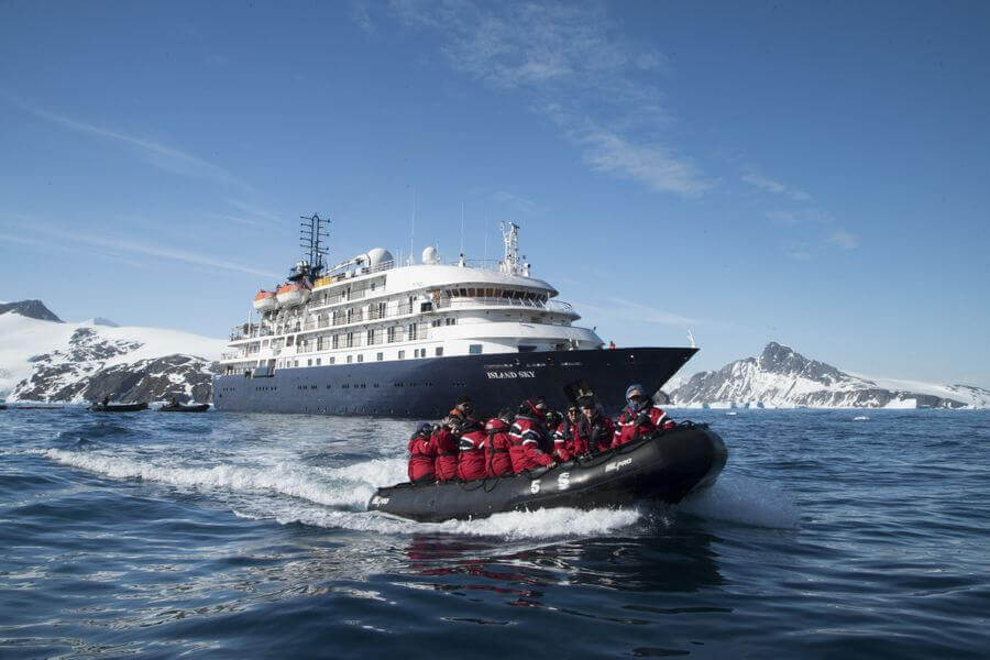 people taking a zodiac boat from the Island Sky ship for a shore excursion in Antarctica