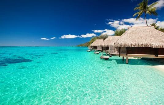 overwater villas in the crystal blue waters of the maldives